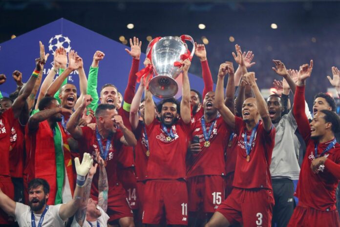Mohamed Salah of Liverpool celebrates with the Champions League Trophy in 2019
